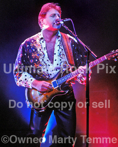 Photo of Greg Lake of Emerson, Lake & Palmer playing a PRS guitar in concert in 1992 by Marty Temme