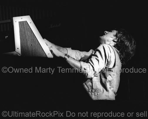 Photo of Keith Emerson of Emerson, Lake and Palmer playing organ in concert in 1977 by Marty Temme