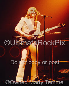 Photo of Greg Lake of Emerson, Lake & Palmer in concert in 1975 by Marty Temme