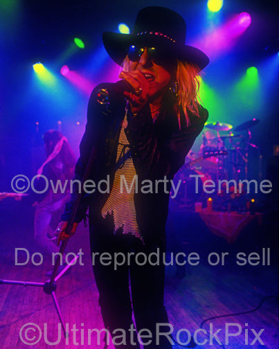 Photo of Taime Downe of Faster Pussycat in concert in 1989 by Marty Temme