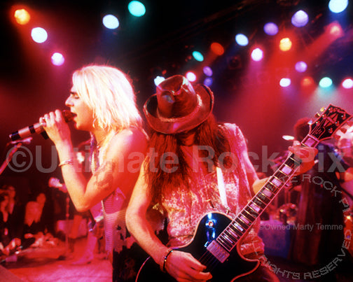 Photo of Taime Downe and Greg Steele of Faster Pussycat in concert in 1989 by Marty Temme