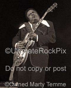 Black and white photo with sepia tint of Freddie King in concert in 1973 by Marty Temme