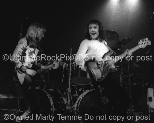 Photo of Dave Peverett and Tony Stevens of Foghat in concert in 1973 by Marty Temme