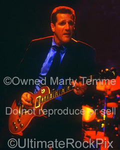 Photo of Glenn Frey of The Eagles playing a Les Paul in concert by Marty Temme