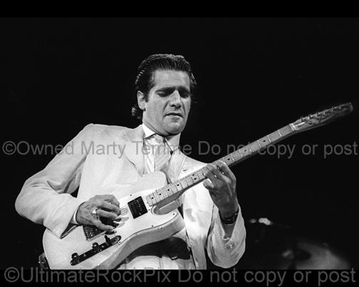 Photo of Glenn Frey of The Eagles playing a Fender Telecaster in concert in 1985 by Marty Temme
