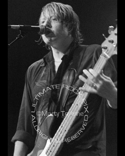 Photo of Jeff Pilson of Foreigner in concert in 2005 by Marty Temme