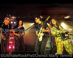 Photos of Guitar Players Joe Satriani, John Petrucci, Steve Vai and Paul Gilbert Performing Together Live in Concert in 1998 in Los Angeles, California by Marty Temme