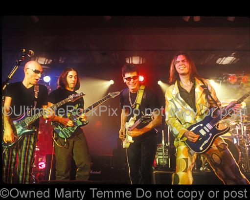 Photos of guitar players Joe Satriani, John Petrucci, Steve Vai and Paul Gilbert in concert in 1998 by Marty Temme