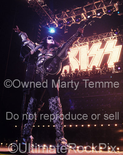 Photo of bass player Gene Simmons in concert by Marty Temme