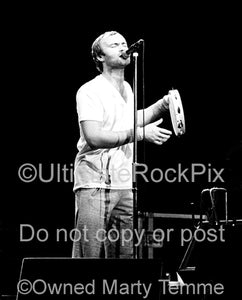 Photo of Phil Collins of Genesis singing in concert 1978 by Marty Temme