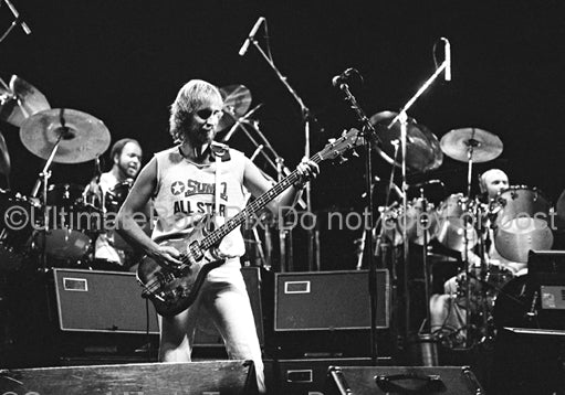 Photo of Phil Collins, Mike Rutherford and Chester Thompson of Genesis onstage in 1977 by Marty Temme