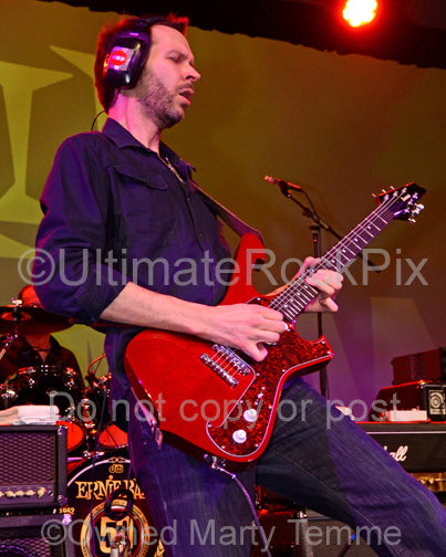 Photo of Paul Gilbert playng an Ibanez guitar in concert in 2012 by Marty Temme