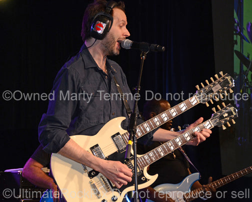 Photo of Paul Gilbert of Mr. Big playing a doubleneck Ibanez in concert in 2012 by Marty Temme