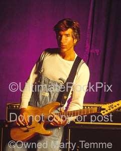 Photo of George Lynch holding a ESP guitar during a photo shoot in 1995 by Marty Temme