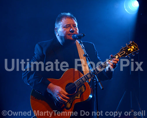 Photo of Greg Lake of Emerson, Lake and Palmer and King Crimson playing a Gibson J-200 in concert in 2012 by Marty Temme