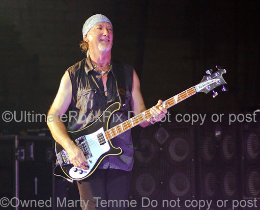 Photo of Roger Glover of Deep Purple playing a Rickenbacker bass in concert in 2007 by Marty Temme