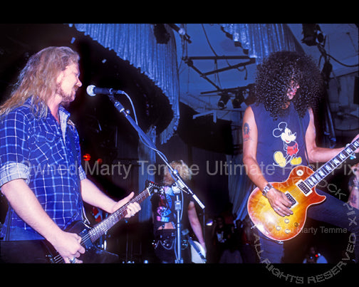 Photo of James Hetfield and Slash playing together onstage in 1990 by Marty Temme