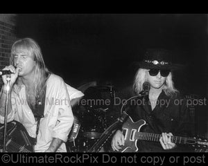 Photo of Jack Russell and Mark Kendall of Great White in concert in 1994 by Marty Temme