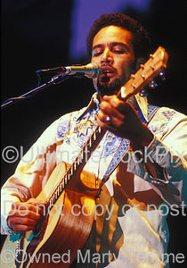Photo of Ben Harper playing a Cole Clark acoustic guitar in concert by Marty Temme