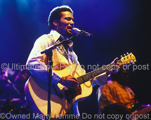 Photo of Ben Harper playing a Cole Clark acoustic guitar in concert in 2004 by Marty Temme