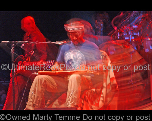 Art Print of Ben Harper playing a lap steel guitar in concert by Marty Temme