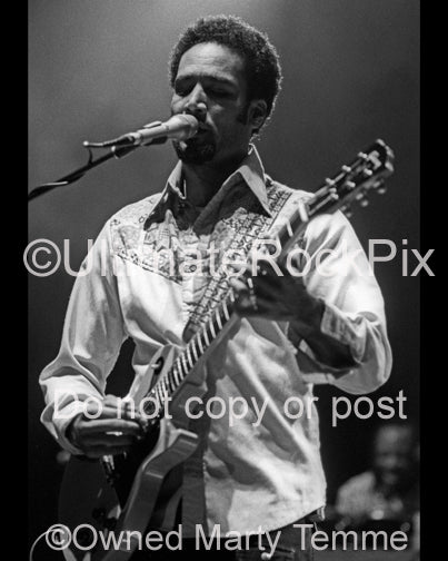 Black and white photo of Ben Harper playing a Les Paul Junior in concert by Marty Temme