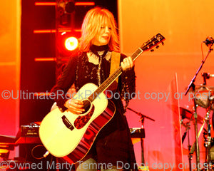 Photo of Nancy Wilson of Heart playing acoustic guitar in concert by Marty Temme