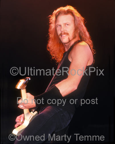 Photo of James Hetfield of Metallica smiling while performing in concert in 1989 by Marty Temme
