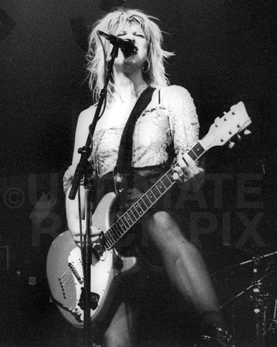 Photo of Courtney Love singing and playing guitar onstage in 1994 by Marty Temme