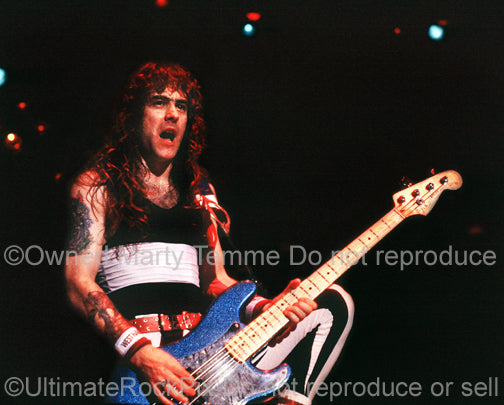 Photo of Steve Harris of Iron Maiden onstage in 1985 by Marty Temme