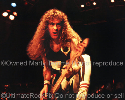 Photo of bass player Steve Harris of Iron Maiden onstage in 1985 by Marty Temme
