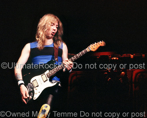 Photo of guitar player Dave Murray of Iron Maiden in concert 1985 by Marty Temme