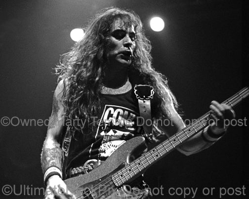 Black and white photo of bassist Steve Harris of Iron Maiden in concert in 1991 by Marty Temme