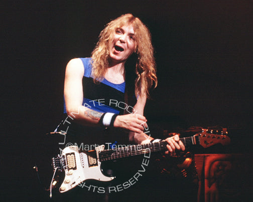 Photo of guitarist Dave Murray of Iron Maiden in concert in 1985 by Marty Temme
