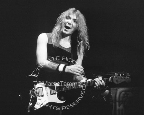Black and white photo of Dave Murray of Iron Maiden in concert in 1985 by Marty Temme