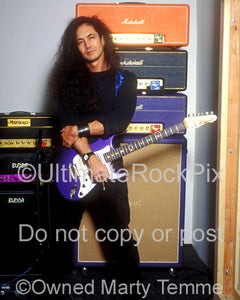 Photo of Jake E. Lee standing in front of his Marshall and Budda amps during a photo shoot in 1995 by Marty Temme