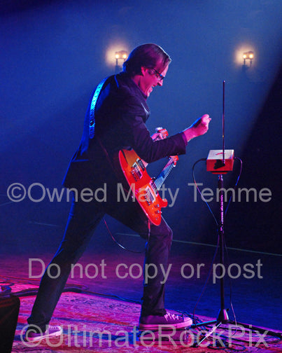 Photo of Joe Bonamassa playing a doubleneck guitar and a theremin in concert by Marty Temme
