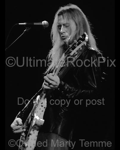 Black and white photo of Jerry Cantrell playing a white Les Paul in concert in 2002 by Marty Temme