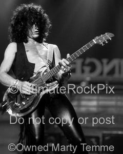 Photos of guitarist Joe Perry playing slide on a Dan Armstrong Plexi guitar in 1990 by Marty Temme