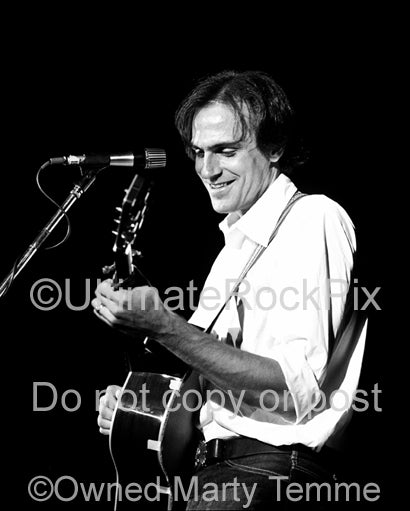 Black and white photo of musician James Taylor in concert in the 1970's by Marty Temme