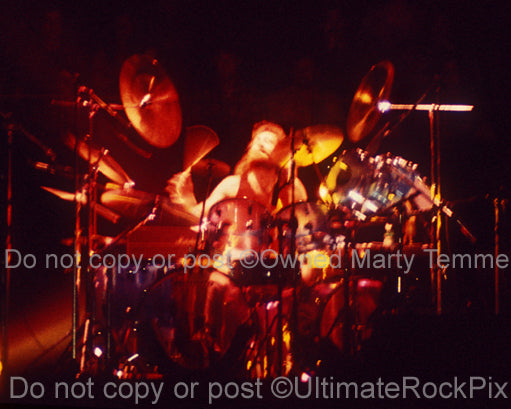 Photo of Barriemore Barlow of Jethro Tull in concert in 1976 by Marty Temme