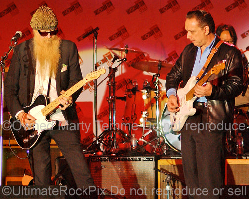Photo of Jimmie Vaughan and Billy Gibbons playing together in concert by Marty Temme