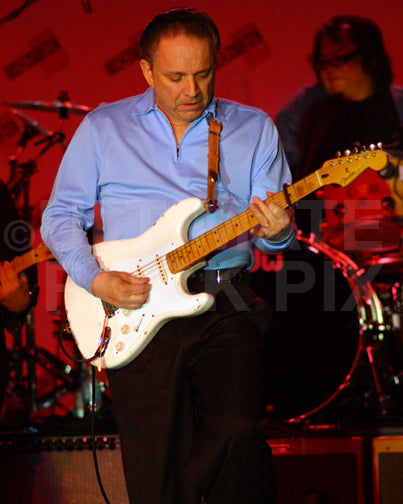 Photo of Jimmie Vaughan playing a Fender Stratocaster in concert by Marty Temme