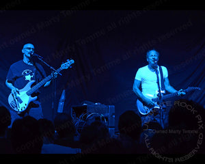 Photo of Tony Levin and Adrian Belew of King Crimson in concert by Marty Temme