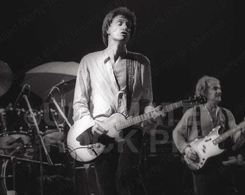 Photo of Ray Davies of The Kinks playing guitar in concert in 1979 by Marty Temme