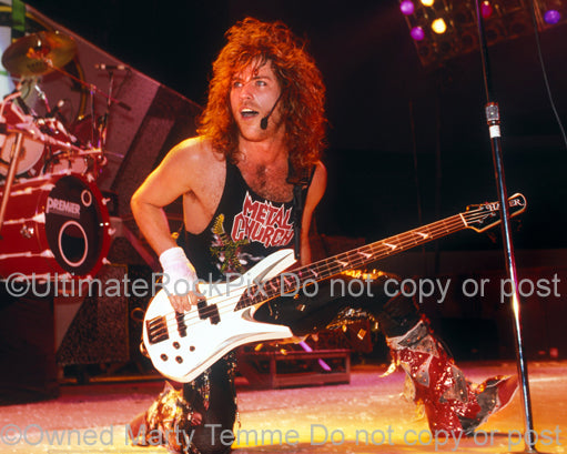 Photo of Kip Winger playing bass in concert in 1989 by Marty Temme