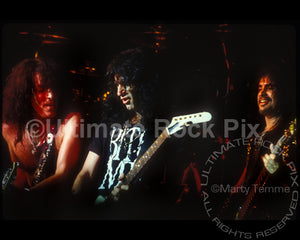 Photo of Paul Stanley, Bruce Kulick and Gene Simmons of Kiss in concert by Marty Temme