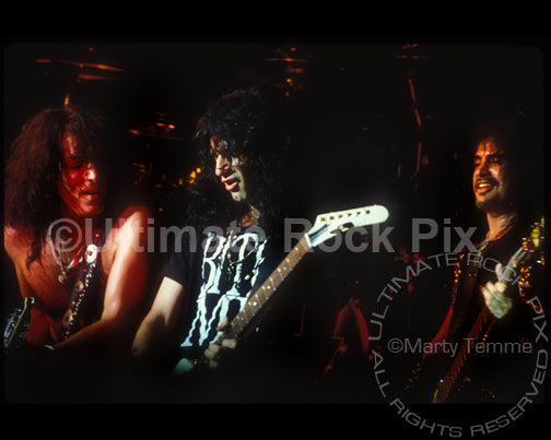 Photo of Paul Stanley, Bruce Kulick and Gene Simmons of Kiss in concert by Marty Temme
