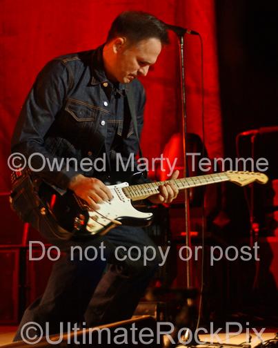 Photo of guitar player Keith Scott of Bryan Adams playing a Fender Stratocaster in concert by Marty Temme