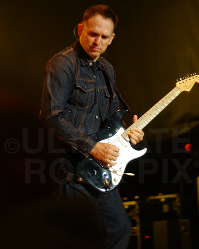 Photo of guitar player Keith Scott of Bryan Adams in concert by Marty Temme
